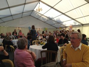 My very large family being led in song by me at a party.