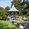 Grange over Sands bandstand on a sunny summer day with The Growing Singers performing for a gathered crowd